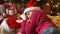 Santa helper boy sleeping and waiting for Santa, lying near decorated xmas tree with lights - Merry Christmas and Happy Holidays!