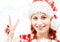 Santa helper showing victory sign with snowflakes