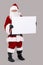 Santa holding blank white board