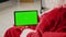 Santa holding green screen tablet