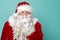 Santa holding index finger over lips, showing to be silent sign