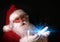 Santa holding magical lights in hands