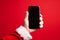 Santa holds a blank smartphone in his hand. Phone template for mockup. Generative AI
