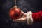 Santa holds an empty Christmas ball in his hand. Mockup for discount or price. Generative AI