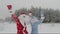 Santa and the joyful granddaughter of the Snow Maiden are dancing happily in nature in the forest. Accelerated video