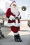 Santa Leaning On Private Jet At Airport Terminal