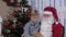 Santa & Little Boy Choose Gifts on Tablet in Room