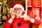 Santa make funny face and picking cookie. Santa Claus in Santa hat. Santa picking cookie and glass of milk at home
