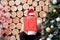 Santa man in red hat peep over present box
