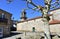 Santa Maria Magdalena medieval church, side view with baroque tower and tree. Ribadavia, Spain.