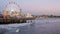 SANTA MONICA, LOS ANGELES CA USA - 19 DEC 2019: Classic illuminated ferris wheel in amusement park on pier. California summertime