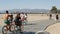 SANTA MONICA, LOS ANGELES CA USA - 28 OCT 2019: California summertime beach aesthetic, people walking and ride cycles on