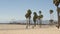 SANTA MONICA, LOS ANGELES CA USA - 28 OCT 2019: California summertime beach aesthetic, people walking and ride cycles on