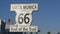 SANTA MONICA, LOS ANGELES, USA - 28 OCT 2019: Historic route 66, famous vintage california trip symbol. Pier of pacific ocean