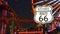 SANTA MONICA, LOS ANGELES, USA - 28 OCT 2019: Iconic road sign glowing, historic route 66. Famous california symbol, pier of