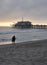 Santa Monica pier in the evening, a couple standing at the beach, the last rays of sunshine