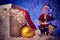 Santa with a mouse figure.Gift box with cap, Golden ball