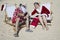 Santa and Mrs Claus taking selfie on beach