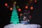 Santa near a beautiful, colourful, New Year`s fir-tree, sits in a glass sphere and prepares gifts for children for new year