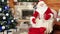 Santa packing bag with presents, christmas gifts for obedient children, room with fireplace