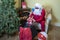 Santa packing suitcase for a beach holiday after Christmas