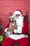 Santa Paws with one white puppy dog