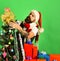 Santa with red presents near decorated fir tree