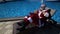 Santa relax at pool and do crazy joke with laptop