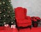 Santa`s Red Chair with Gifts and a Decorated Christmas Tree