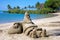 Santa sandcastle figure on beach