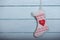 Santa socks hang on white wood background