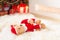 Santa tedyy bear toy lie on sheepskin near illuminated christmas