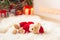 Santa tedyy bear toy on sheepskin near illuminated christmas tree