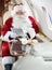 Santa Using Digital Tablet In Private Jet