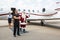 Santa Waving Hand Against Private Jet