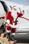 Santa Waving Hand While Standing On Private Jet\'s