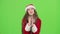 Santa woman sings in a retro microphone and dances with energetic music. Green screen