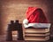 Santas hat over books near black binocular