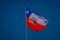 SANTIAGO, CHILE - SEPTEMBER 13, 2018: Outdoor view of Chilean flag waving in a gorgeous bluse sky background in the city