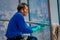 SANTIAGO, CHILE - SEPTEMBER 13, 2018: Outdoor view of unidentified man cleanning the mirror of Skyline of Santiago de