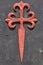 Santiago cross symbol with textured black background. Pilgrimage route. Catholicism