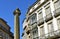 Santiago de Compostela, Cervantes Square. Cervantes Column and houses. Blue sky, sunny day. Spain.