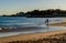 Santo Amaro de Oeiras - March 10, 2019 - Portuguese coastline, silhouettes of father and son playing near the sea on the beach