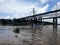 SANTO DOMINGO, DOMINICAN REPUBLIC - APR 14, 2017: Precarious houses under bridge on the banks of the Ozama River