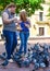 Santo Domingo, Dominican Republic. Women feeds pigeons on Columbus Park, Colonial Zone of Santo Domingo.