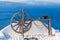 Santorini background card. Wooden wheel against sea