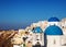 Santorini blue dome churches in Oia Village, Greece.