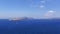 Santorini, Caldera. View of the beautiful blue sea and the three volcanic islands in the middle of Caldera. In the background is