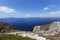 Santorini, Caldera, view from the rocky coastline of the Caldera and two volcanic islands .In the background Oia. Down on the