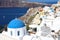 Santorini famous blue domes of white village Oia with volcano ca